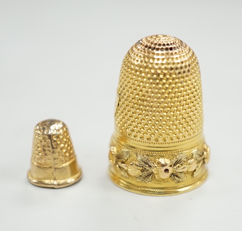 A French yellow metal (18ct poincon mark) thimble, 22mm, 5.4 grams and a tiny 1960's 9ct gold thimble, 9mm, 0.5 grams.